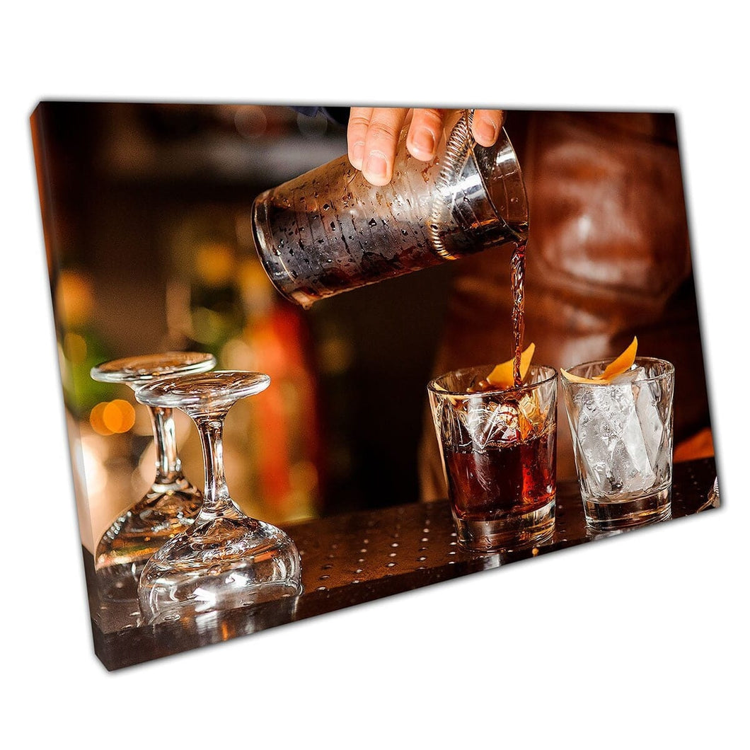 Barman Pouring Alcoholic Beverage Into Glasses With Ice And Orange Peel Wall Art Print On Canvas Mounted Canvas print